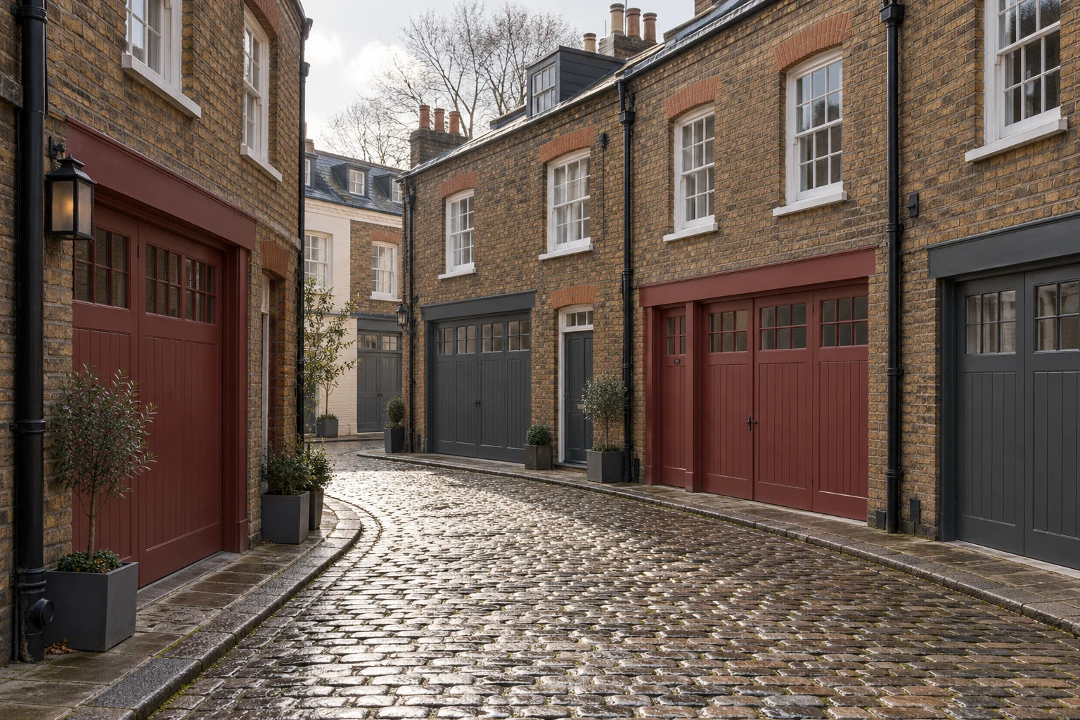 Cobbled mews with brown-brick houses and clay-red and slate-grey garage doors